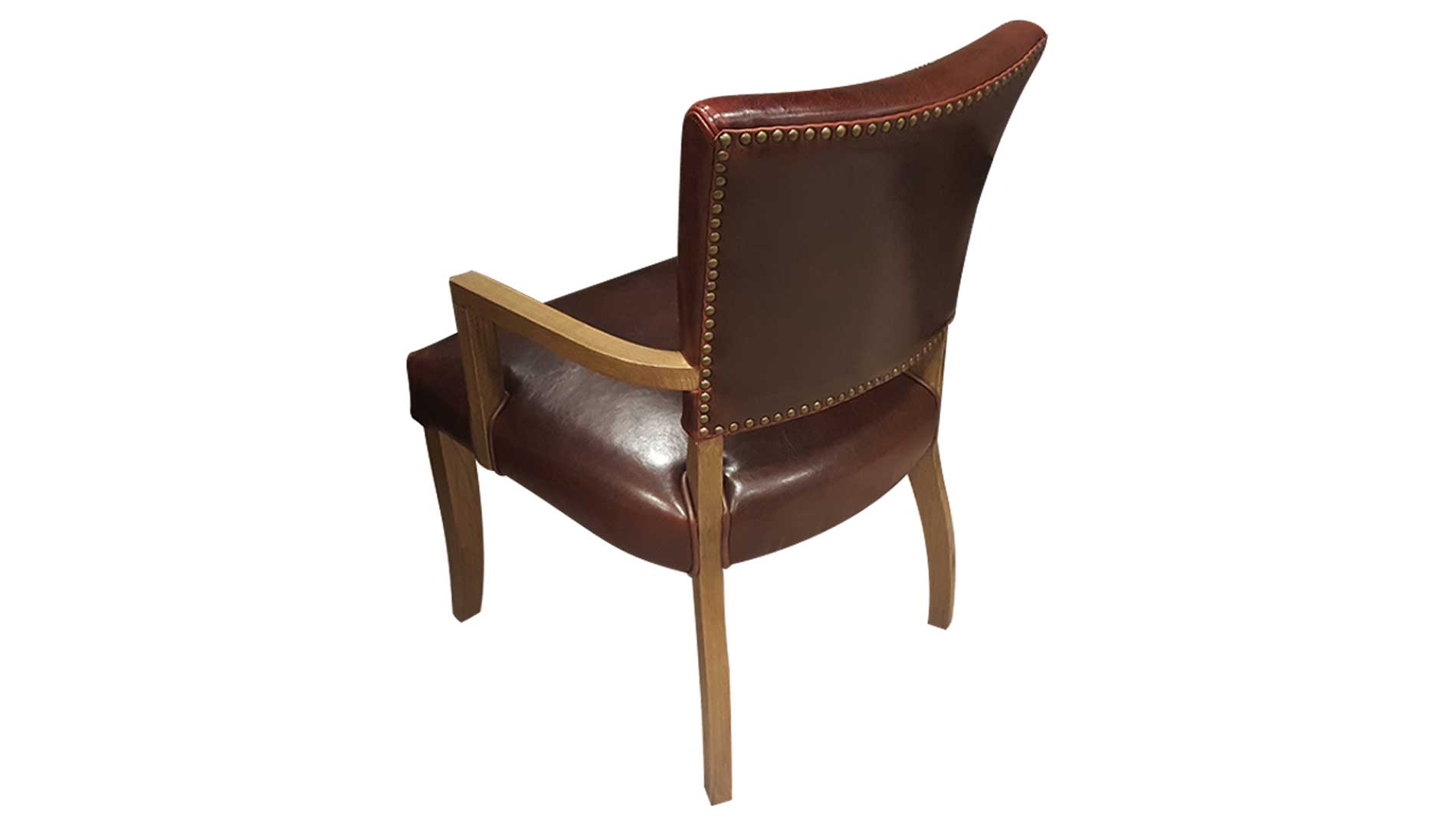 brown leatherupholstered dining chair with arms